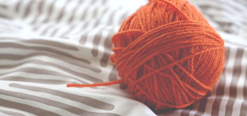 orange Wolle auf einem Duvet